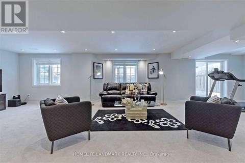 A living room with a black sofa and a coffee table.