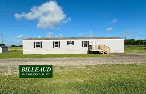 A white building with the words Billeaud Management Co., Inc. on the bottom left corner.