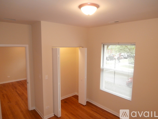 A room with a window and wooden floors.