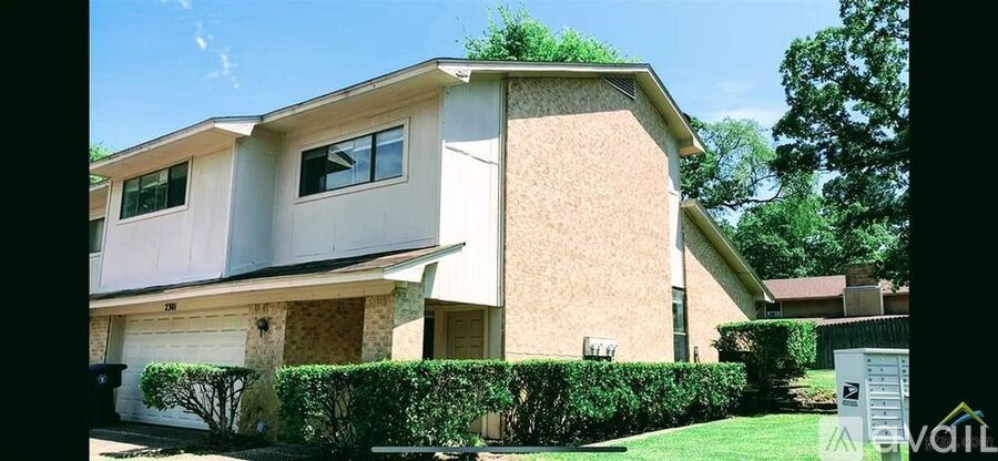A house with a white garage door and a brown wall.