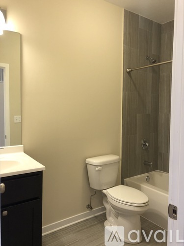 A bathroom with a toilet, sink, and shower.