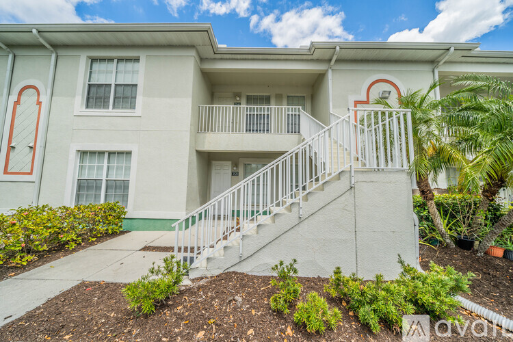 A two-story building with a balcony and staircase.