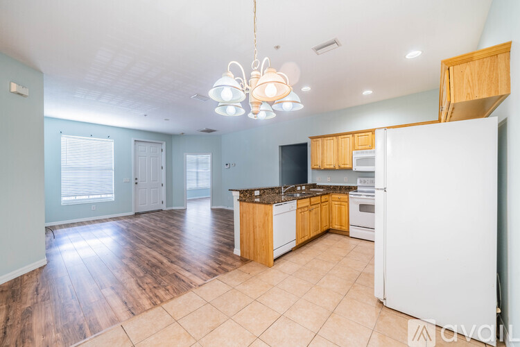A kitchen with wooden cabinets and a white refrigerator.