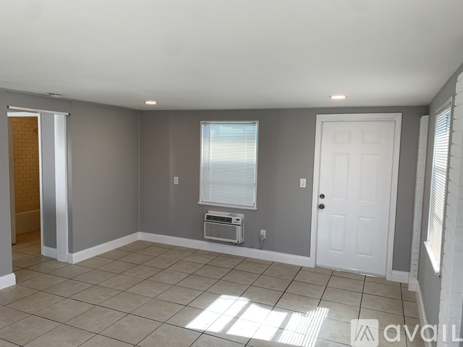 A room with a window and a door.