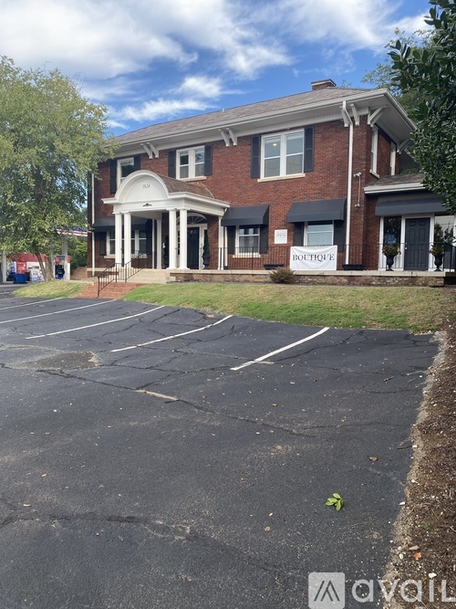 A brick building with a sign that says "Bolton" in front of it.