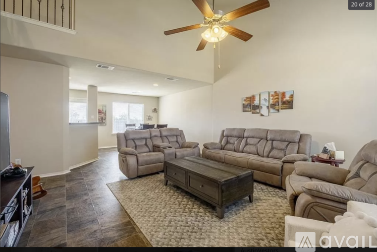A living room with a brown leather couch and a wooden coffee table.