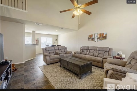 A living room with a brown leather couch and a wooden coffee table.