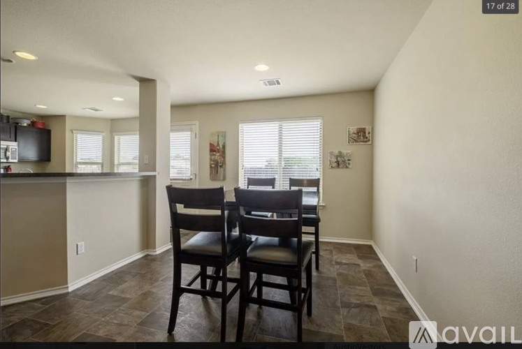 A dining room with a table and chairs.