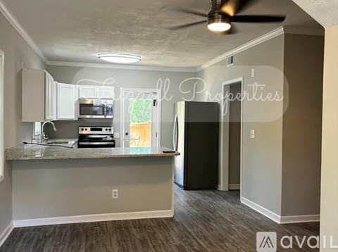 A kitchen with a counter and a fridge is available for rent.