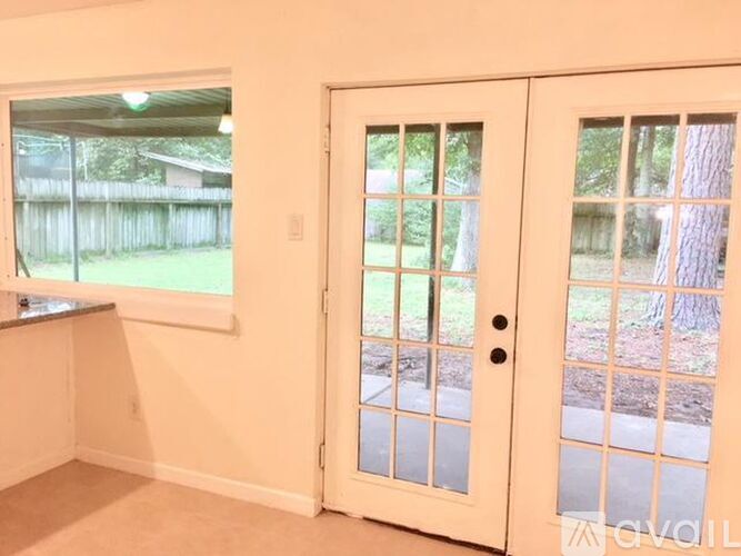 A white door with a glass window is open.