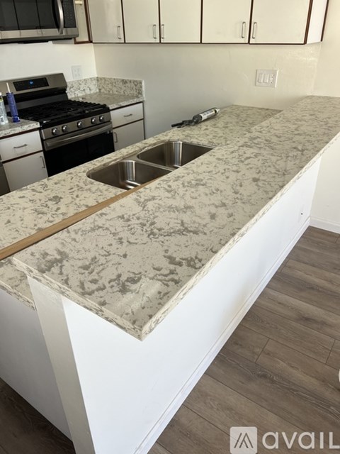 A kitchen with a granite countertop and a sink.