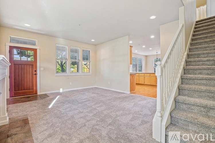 A spacious room with a staircase leading to the upper floor.