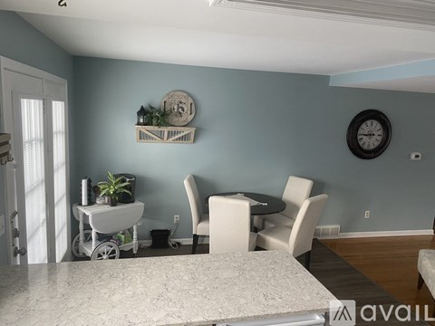 A dining area with a table and chairs.