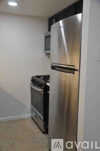 A kitchen with a stainless steel refrigerator and stove.