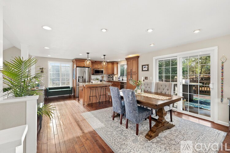 A modern kitchen with a dining table and chairs.