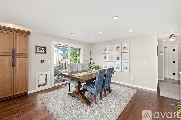 A dining room with a wooden table and chairs.