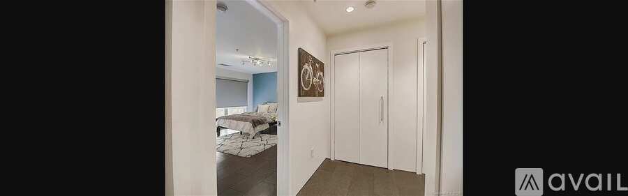 A bedroom with a bed and a painting on the wall.