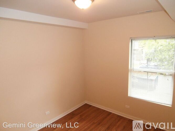 A room with a window and wooden flooring is available for rent.