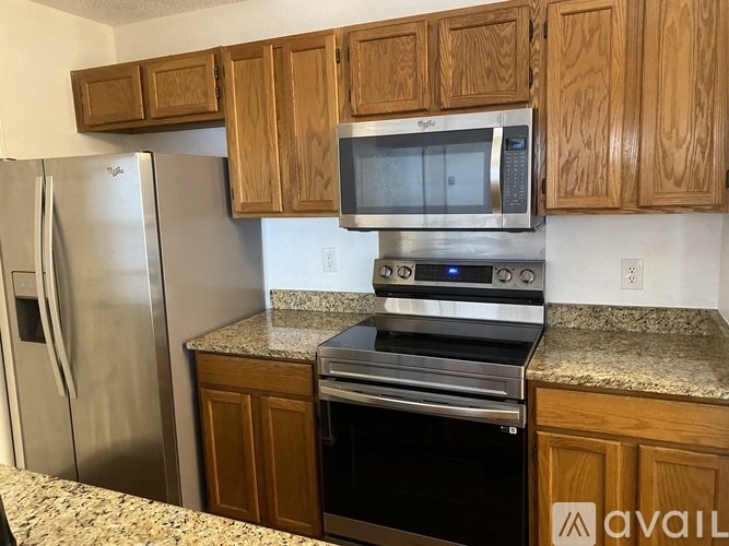 A kitchen with wooden cabinets and stainless steel appliances.