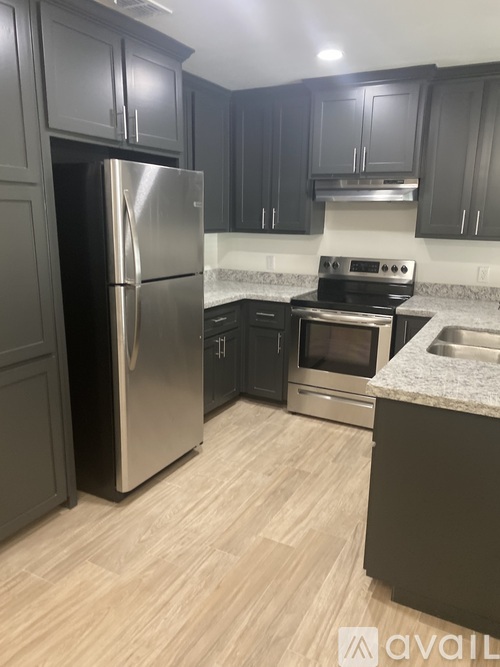 A kitchen with a stainless steel refrigerator and oven.