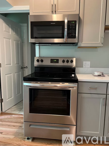 A kitchen with a stainless steel oven and microwave.