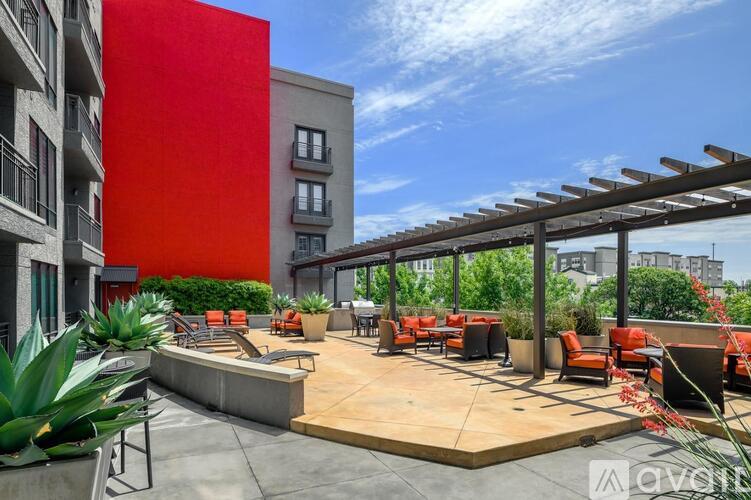 A red building with a patio area in front.