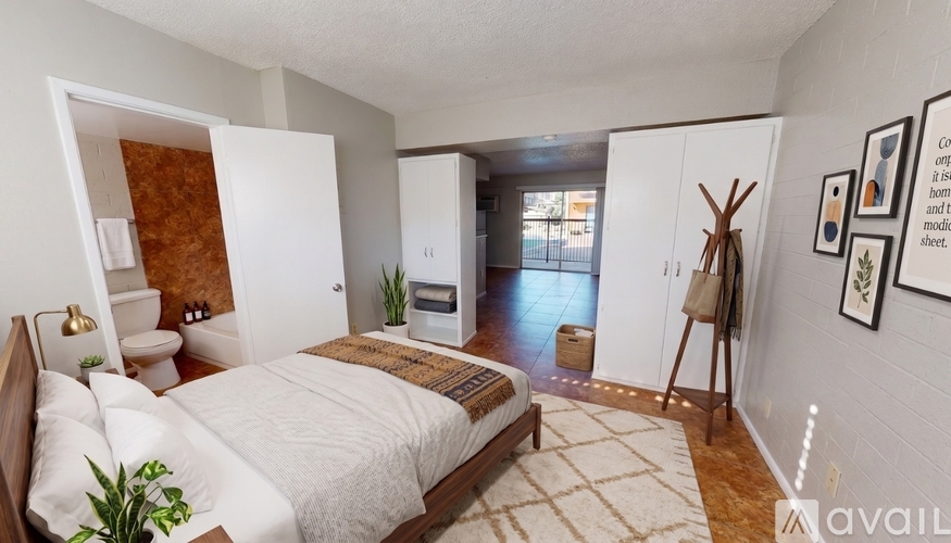 A bedroom with a large bed and a mirror on the wall.