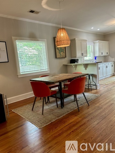 A dining room with a table and chairs.