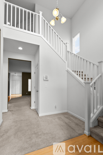 A spacious hallway with a staircase leading to the second floor.