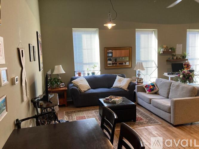 A living room with a black table and a blue couch.
