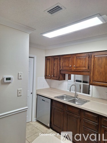 A kitchen with wooden cabinets and a dishwasher.