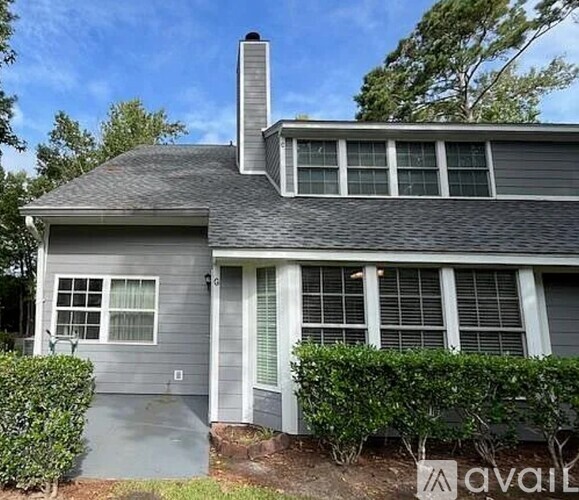 A house with a grey exterior and a chimney on the roof.