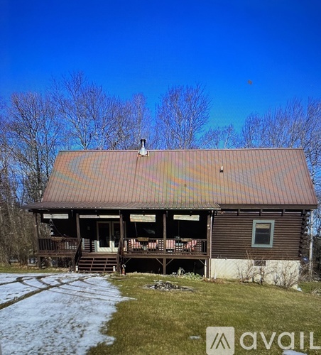 A house with a brown roof and a porch.