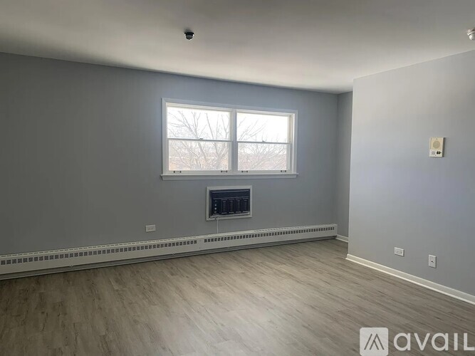 A room with a fireplace and a window.