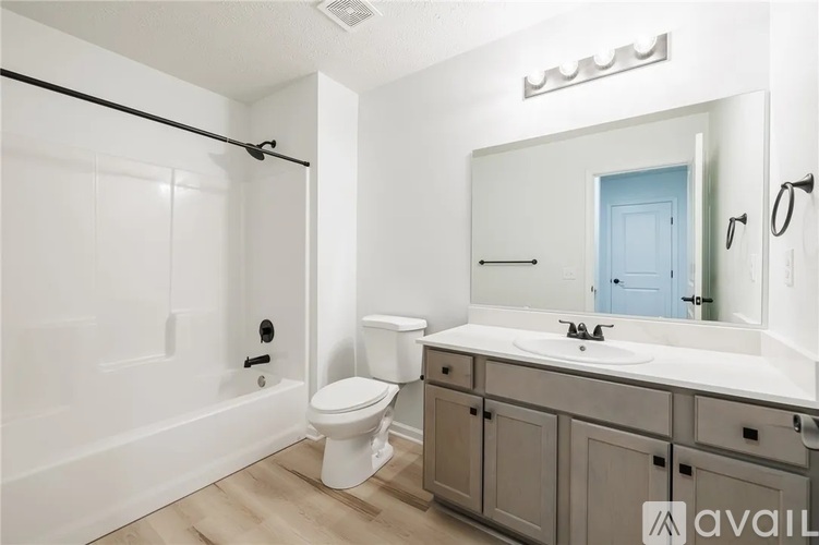 A bathroom with a white toilet, a white sink, and a white bathtub.
