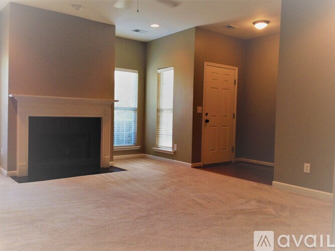 A living room with a fireplace and a door.