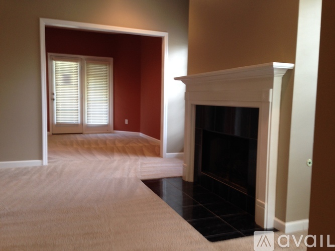 A bedroom with a fireplace and a bed.