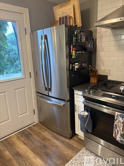 A kitchen with a stainless steel refrigerator and oven.