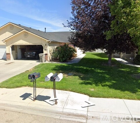 A house with a driveway and a mailbox.