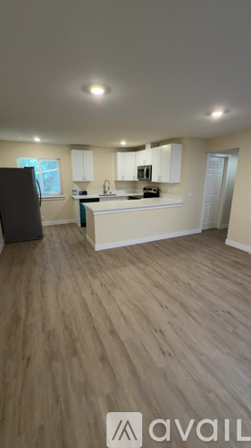 A kitchen with a refrigerator, microwave, and oven.