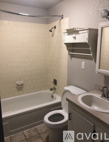 A bathroom with a toilet, sink, and bathtub.
