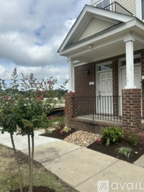 A small house with a white door and a brick wall.