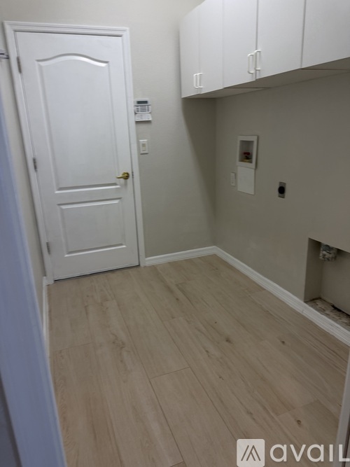 A white door is on the left and a white cabinet is on the right.