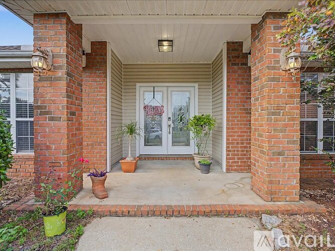 A house entrance with a glass door and a brick pillar.