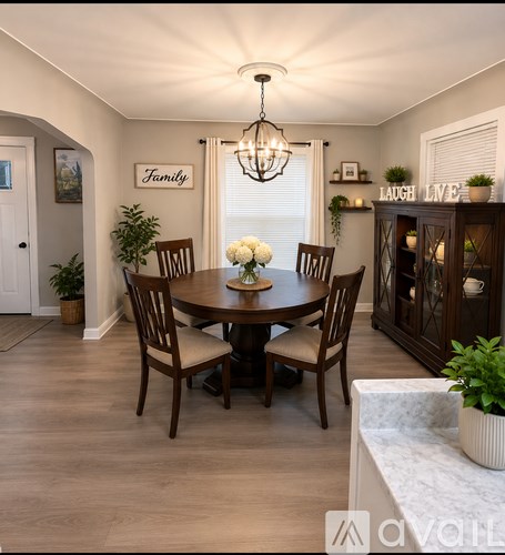 A dining room with a wooden table and chairs.