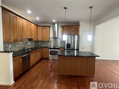 A kitchen with wooden cabinets and a black countertop.