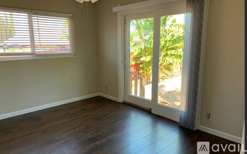 A room with a sliding glass door leading to a patio.