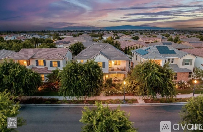 A row of houses with trees in front of them.