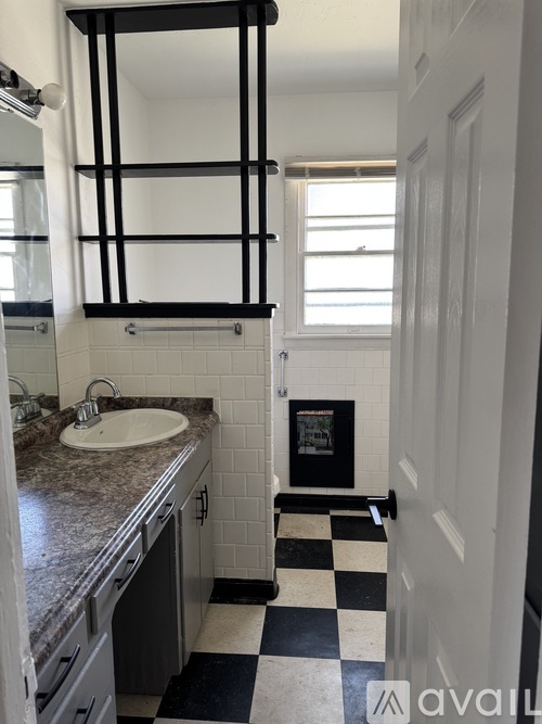 A bathroom with a black and white checkered floor.