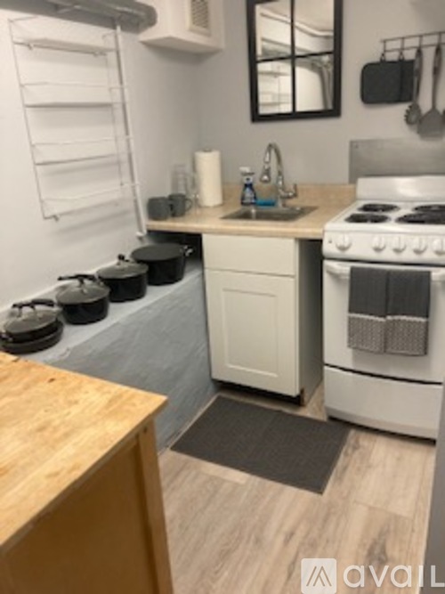 A kitchen with a white stove and a wooden counter.